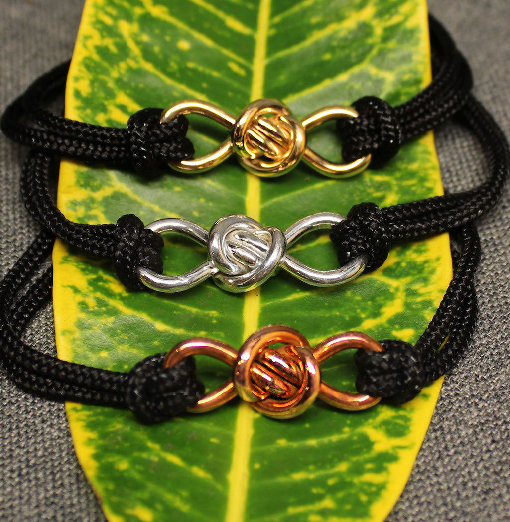 3 adjustable black nylon cord bracelets with copper, 14k gold and sterling silver infinity shaped Crucian knot charms.
