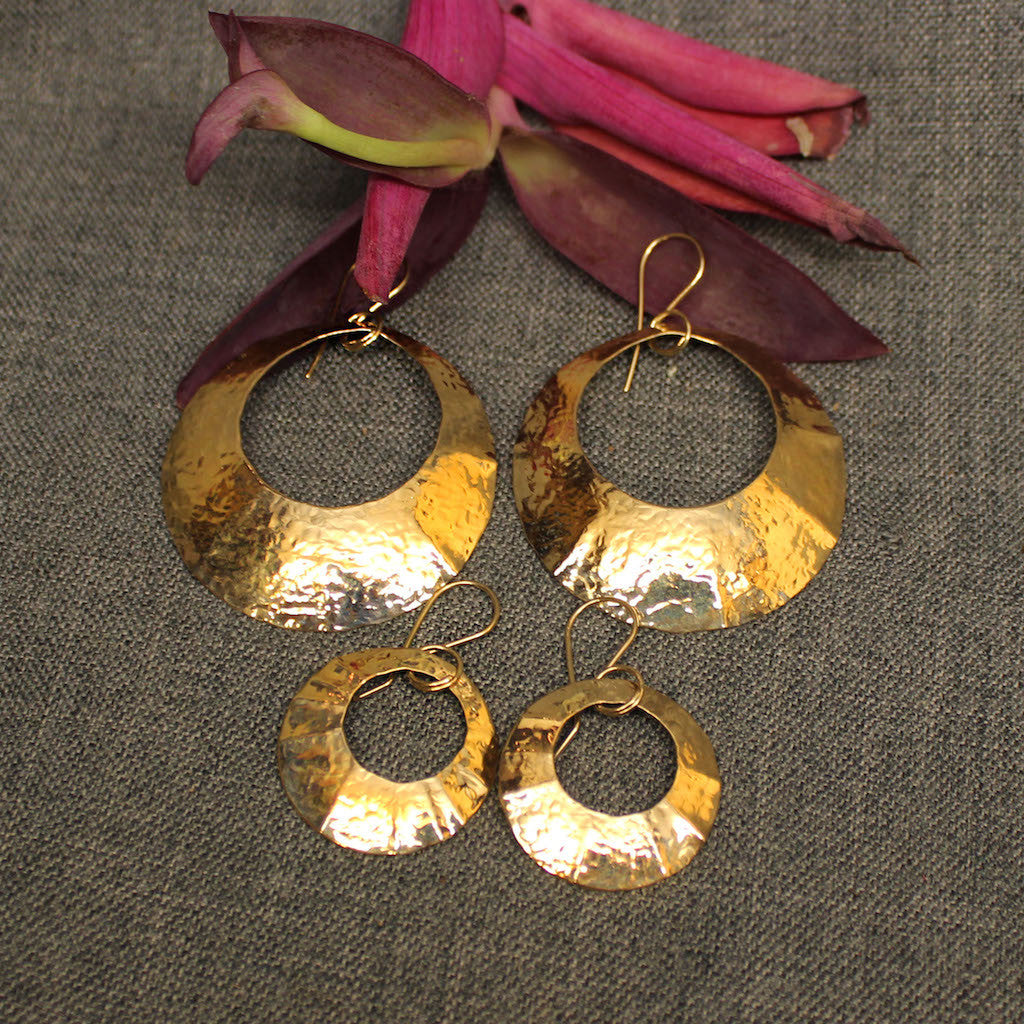 Small and large 14k gold hammered circular earrings.