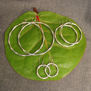 Handcrafted small, medium and large sterling silver hoop earrings.