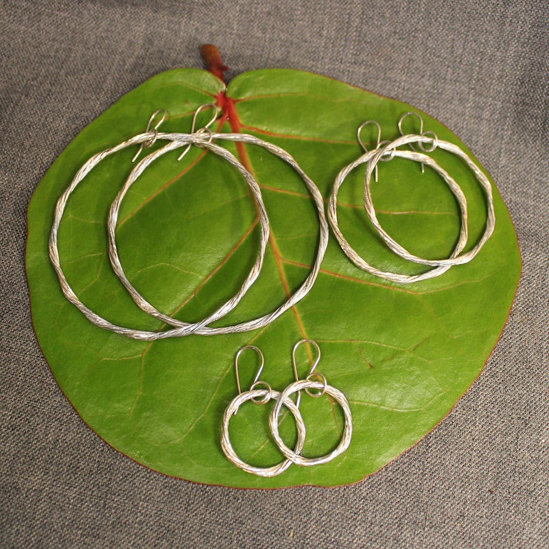 Handcrafted small, medium and large sterling silver hoop earrings.