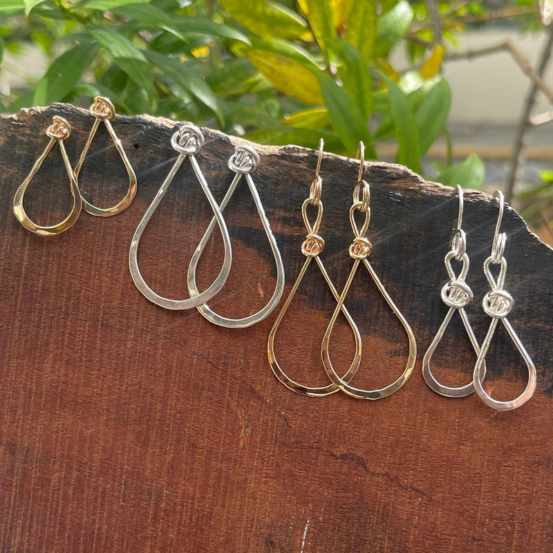 Small and large sterling silver and 14k gold teardrop earrings.