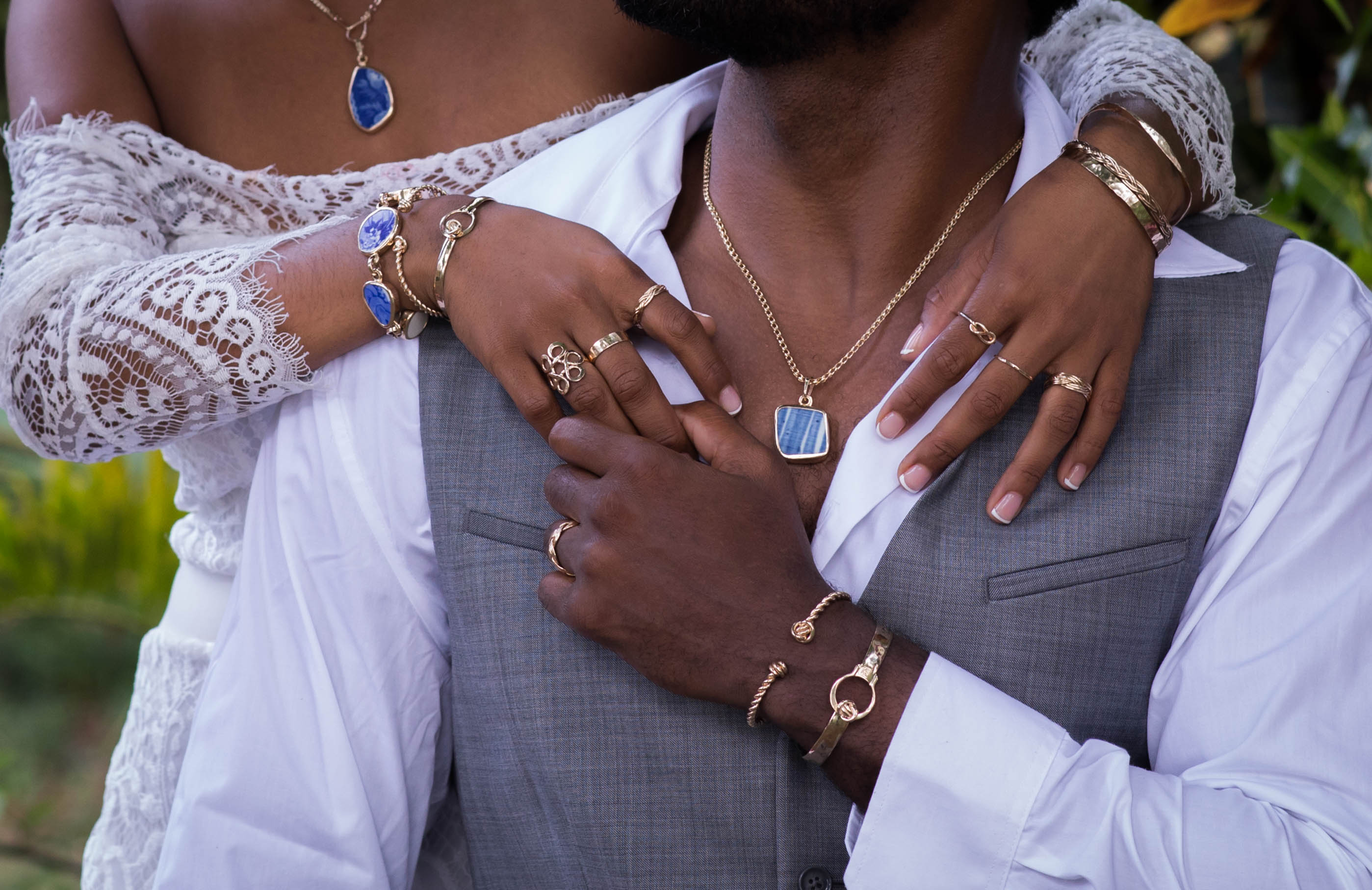 wedding portrait of Two people wearing jewelry with a blurred natural background
