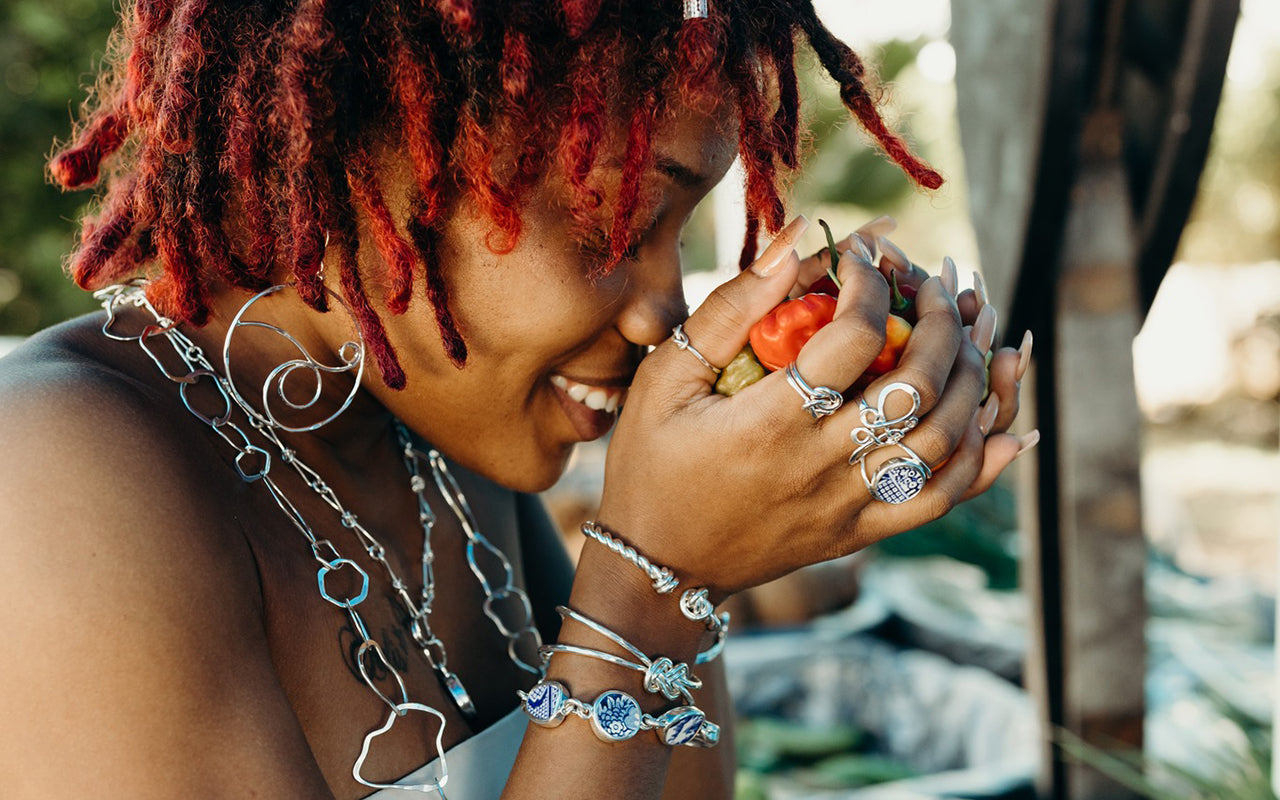 Woman holding peppers wearing jewelry