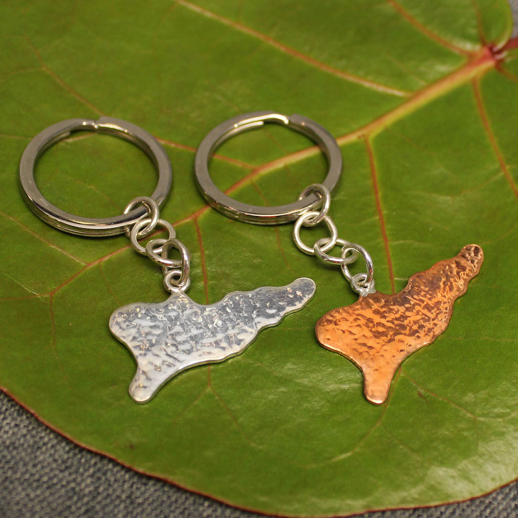 Hammered copper and sterling silver keychains shaped like the map of St.Croix.