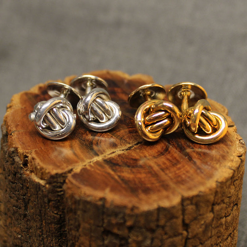 Small Sterling silver and 14k gold cufflinks with round Crucian knot design.
