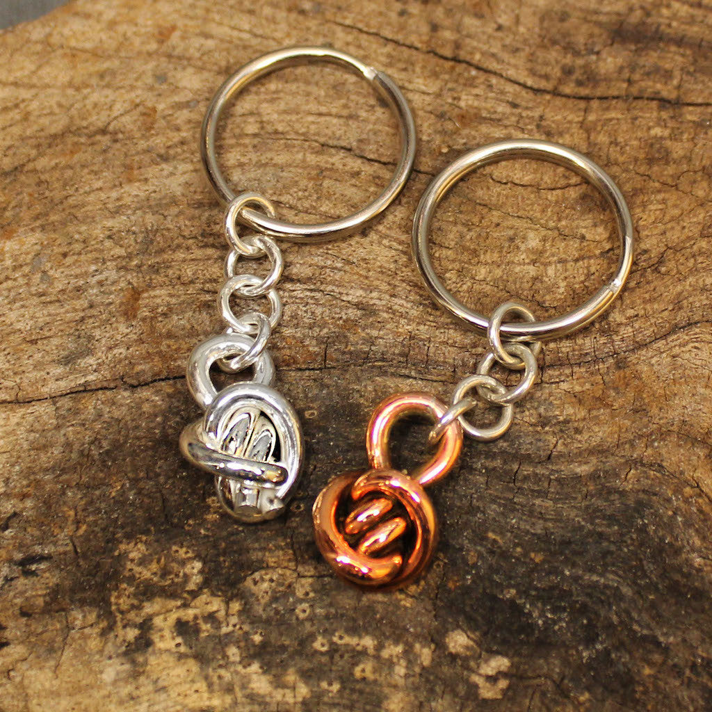 Sterling silver and coper keychains with Crucian Knot design.