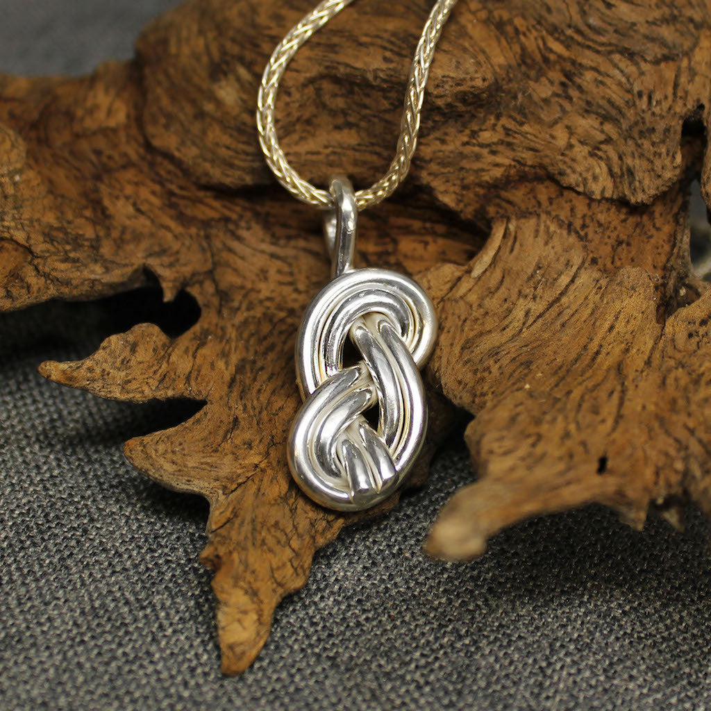 Sterling silver pendant with double infinity knot design.