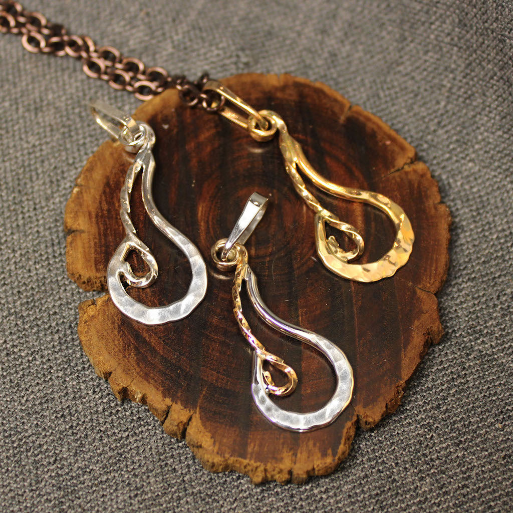 Handcrafted Sterling silver, 14k gold and Sterling silver with 14k gold pendants with fire design.