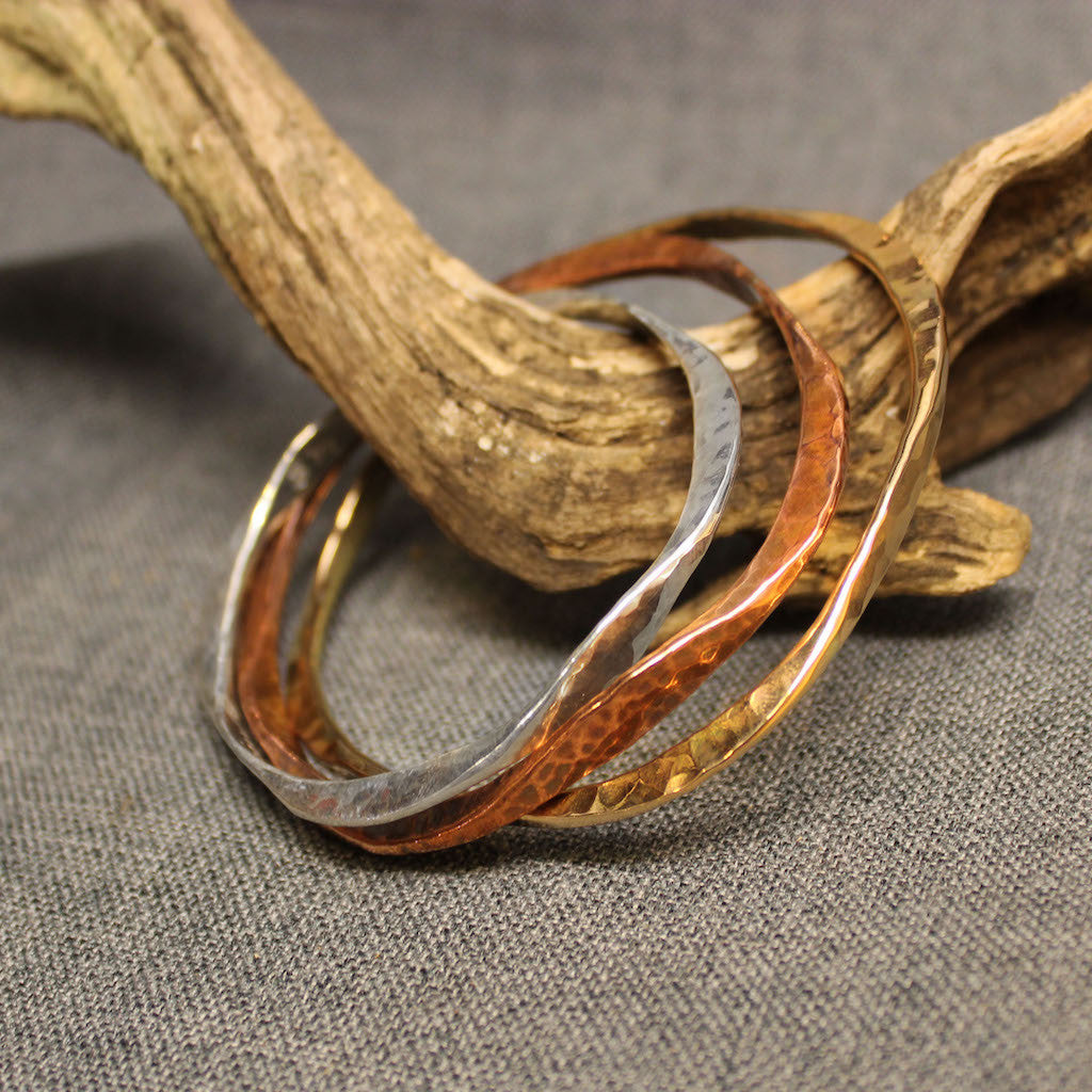 Handcrafted artisan bangles available in copper, sterling silver and 14k gold.