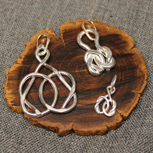 Small, medium and large sterling silver pendants with friendship knot design.