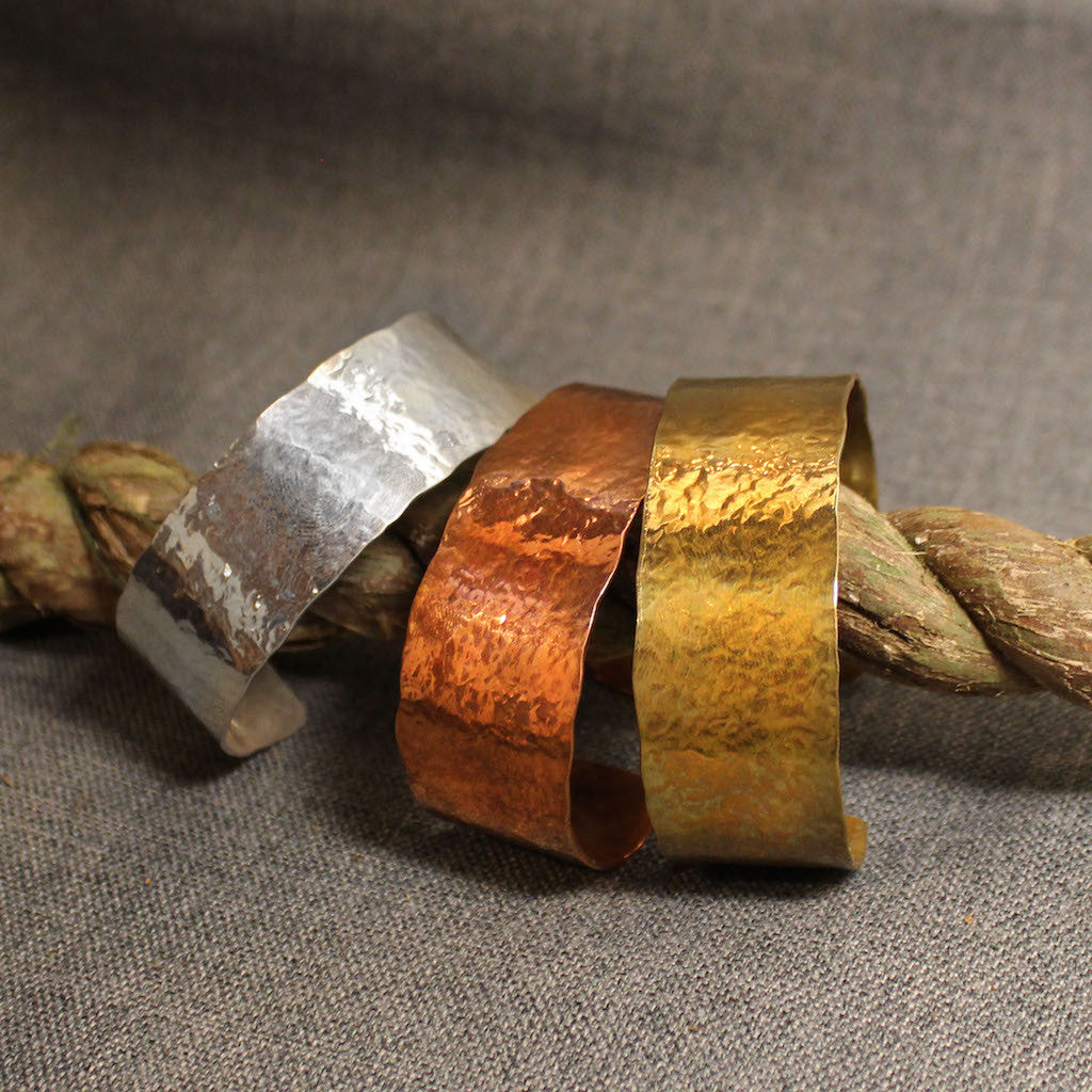 Hammered wide cuff bracelets available in copper, sterling silver and 14k gold.
