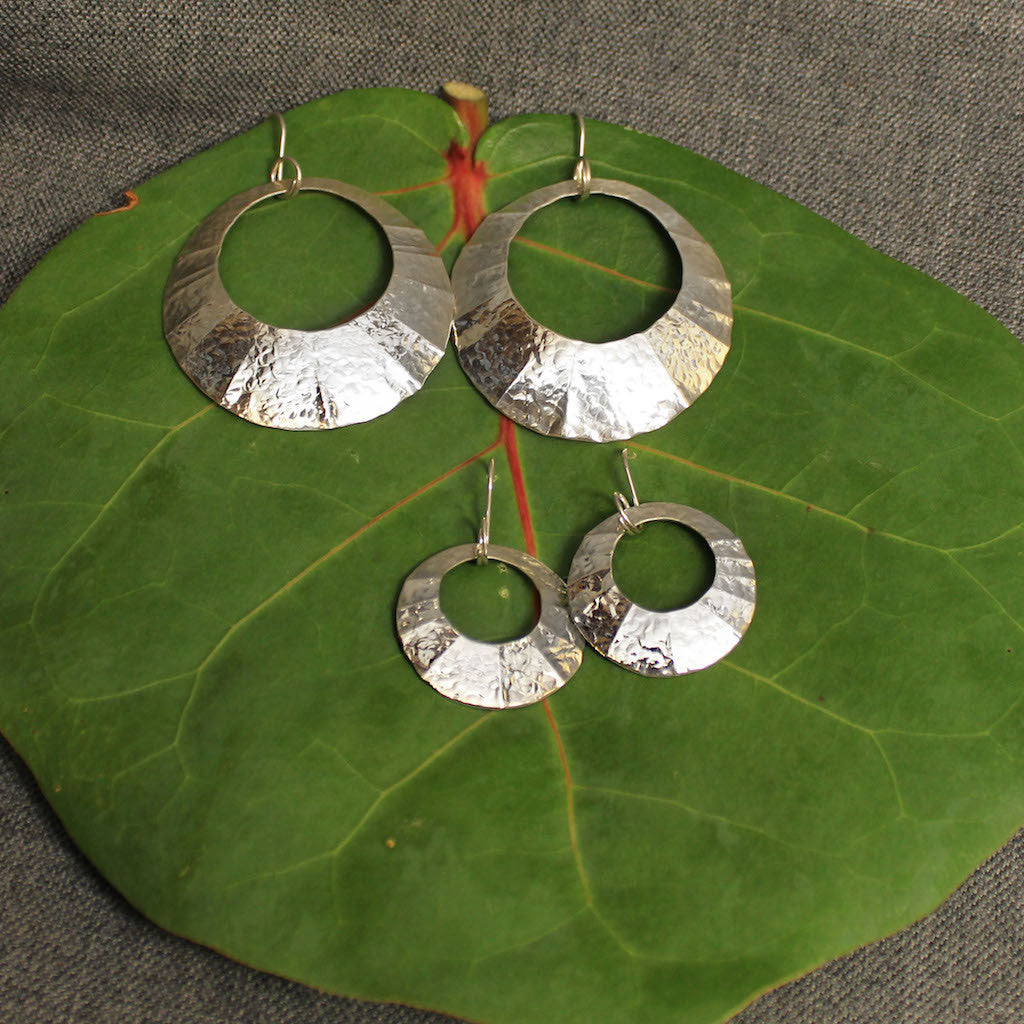 Small and large sterling silver hammered circular earrings.