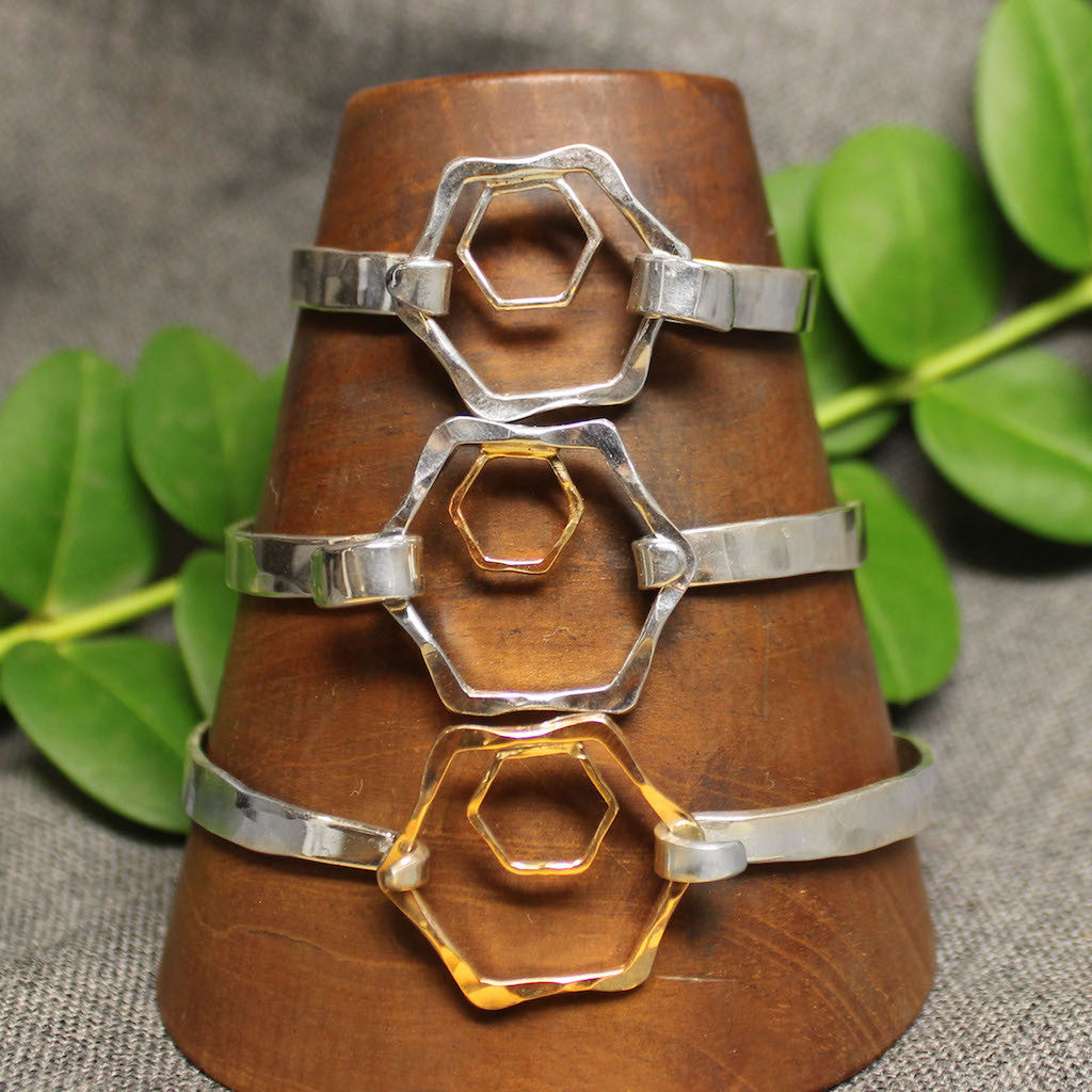 Sterling silver, 14k gold and 2 tone 5mm latching bracelet with small and large hexagonal design in center.