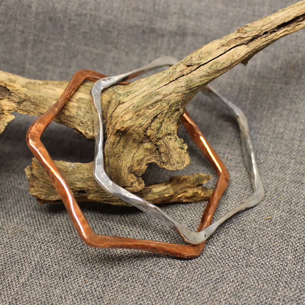 Handcrafted copper and sterling silver hexagonal bangles.