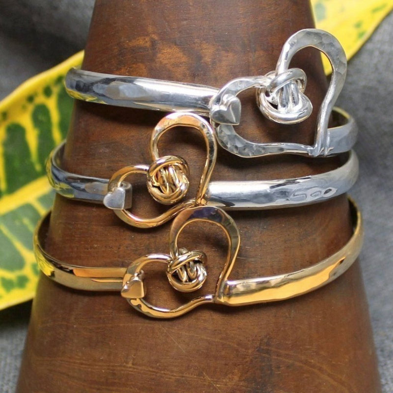 Sterling silver, 14k gold and 2-tone classic handcrafted bracelet with heart design and love knot in center.