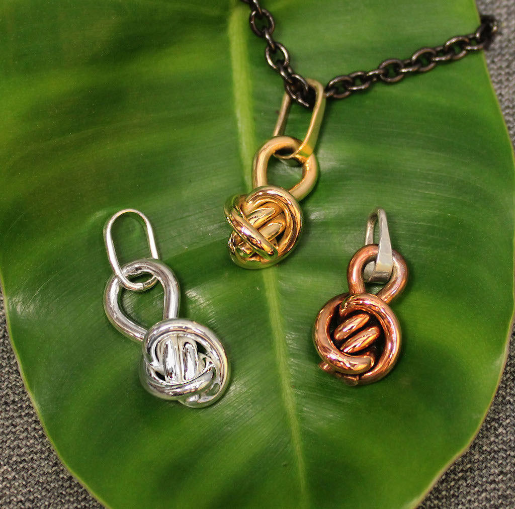 Copper, Sterling silver and 14k gold ball shaped pendants with Crucian knot design.