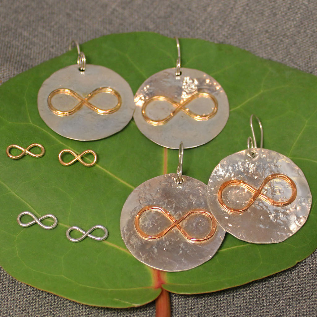 Hammered sterling silver disc earrings with copper or 14k gold infinity symbol in center. Small sterling silver and 14k gold infinity symbol post earrings also pictured.