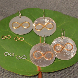 Hammered sterling silver disc earrings with copper or 14k gold infinity symbol in center. Small sterling silver and 14k gold infinity symbol post earrings also pictured.