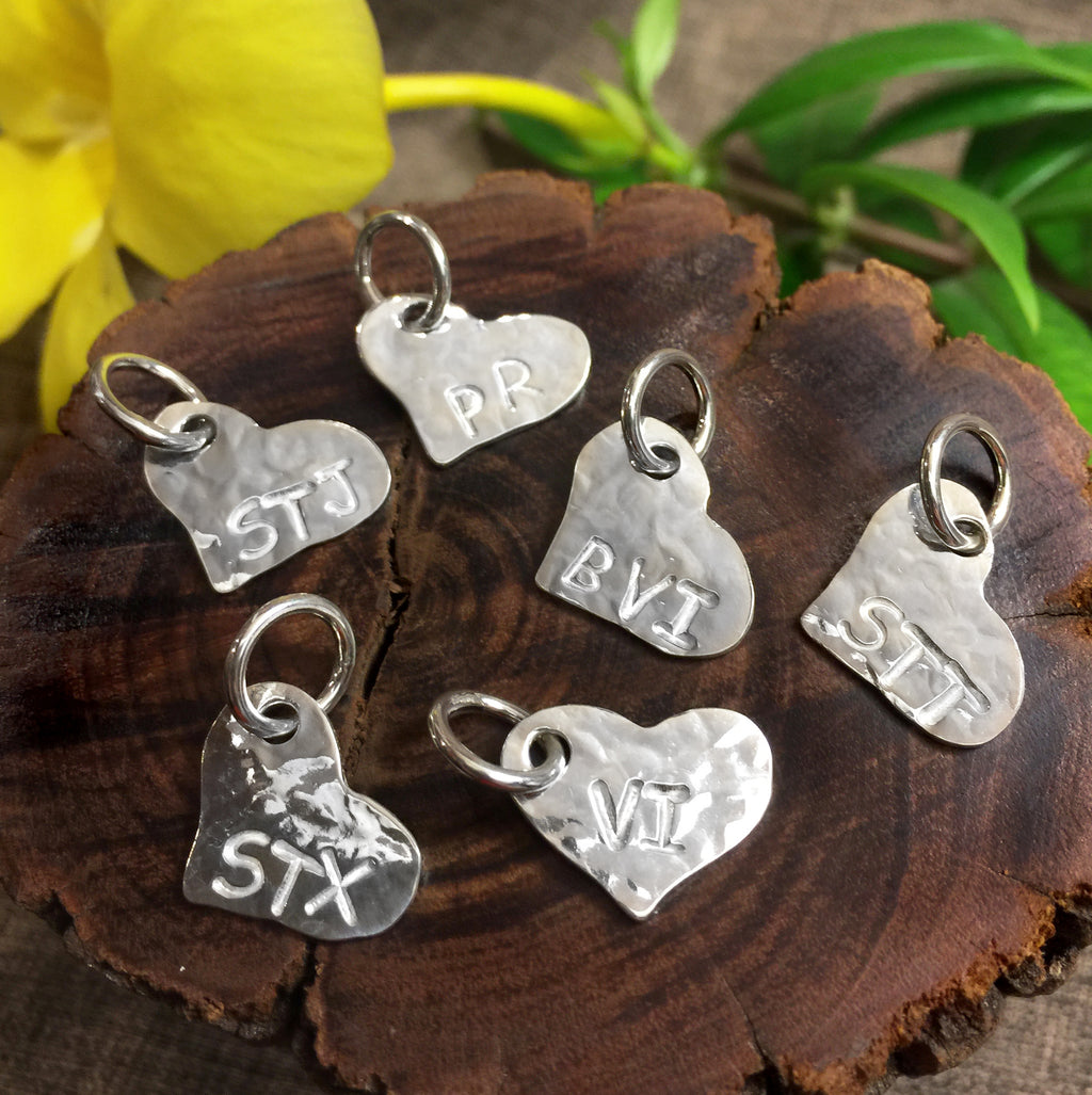 Hammered sterling silver flat heart shaped charms with STX, VI, STT, STJ, PR and BVI engraving.