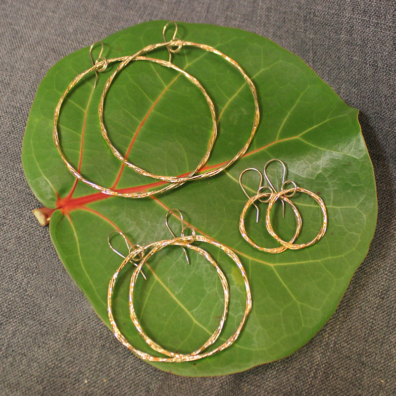 Handcrafted artisanal 14k gold hoop earrings.