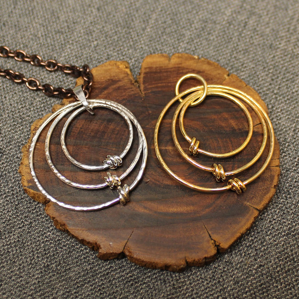 Sterling silver and 14k gold pendants with 3 tiered hoops.