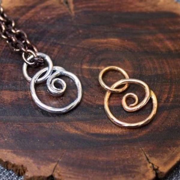 Sterling silver and 14k gold spiral charms.