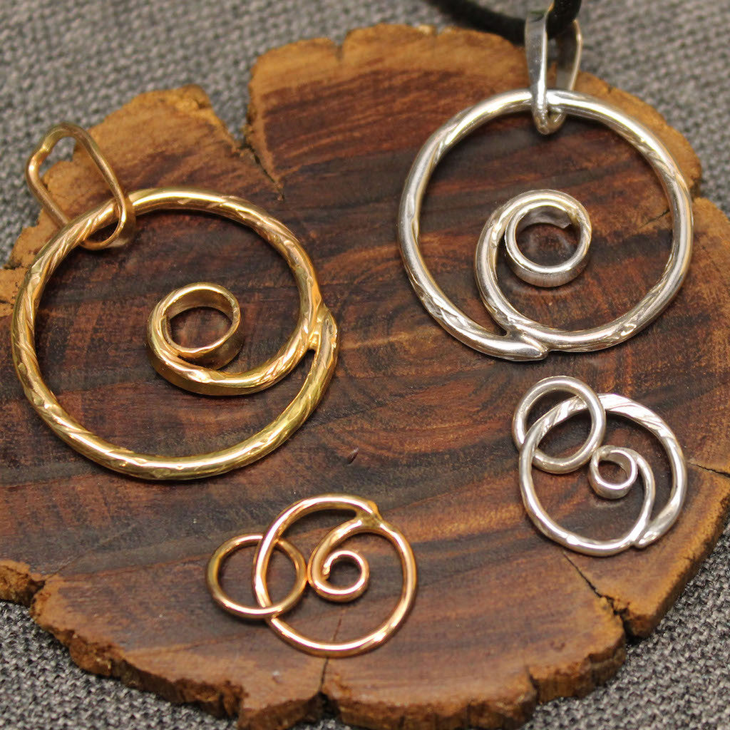 Small and larger sterling silver and 14k gold spiral pendants.