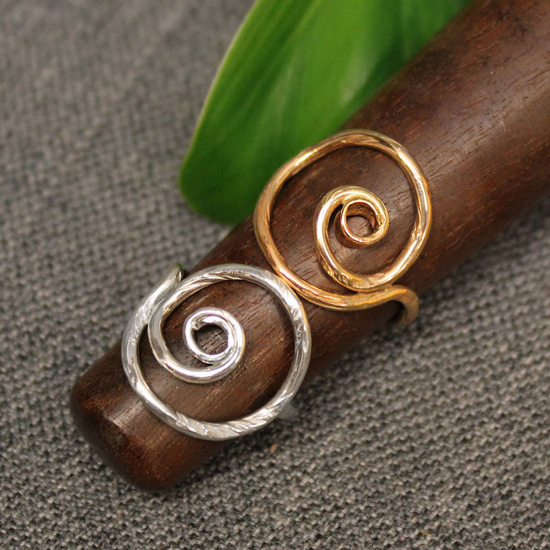 Sterling silver and 14k gold spiral rings.