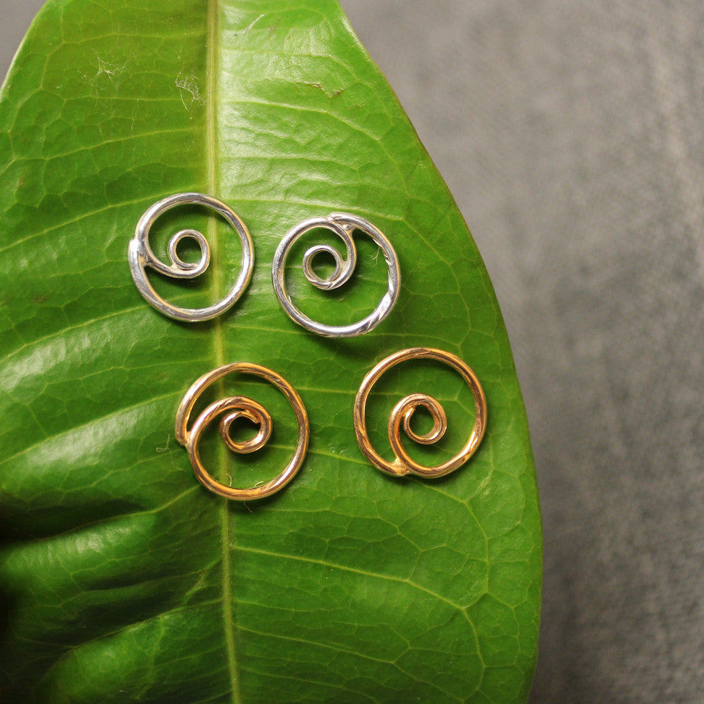 Sterling silver and 14k gold spiral post earrings.