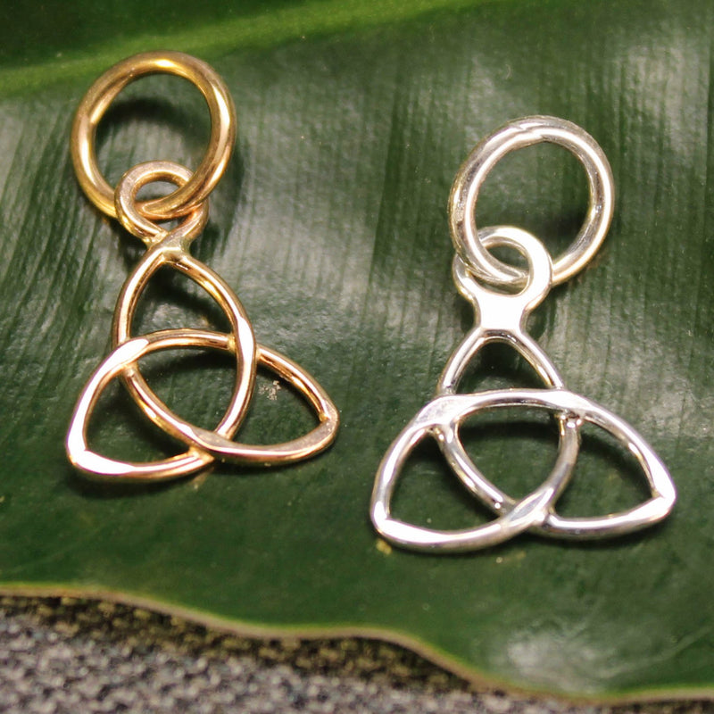 Sterling silver and 14k gold Trinity Knot charms.