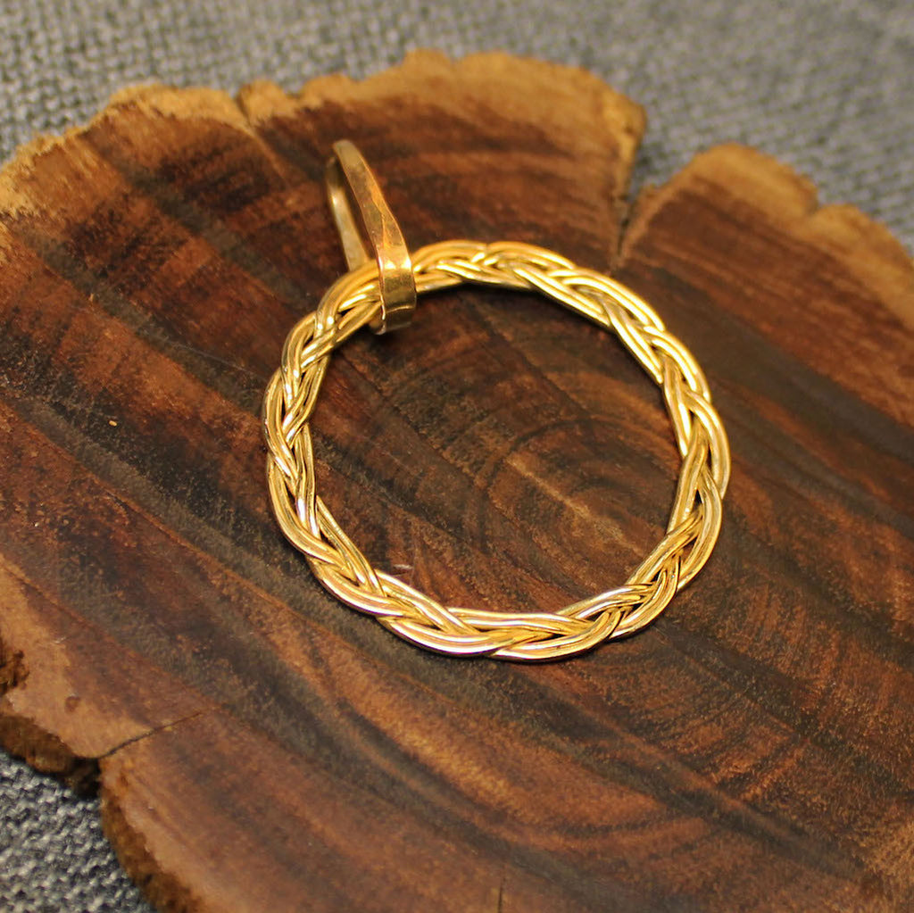 Circular 14k gold pendant with rope design.