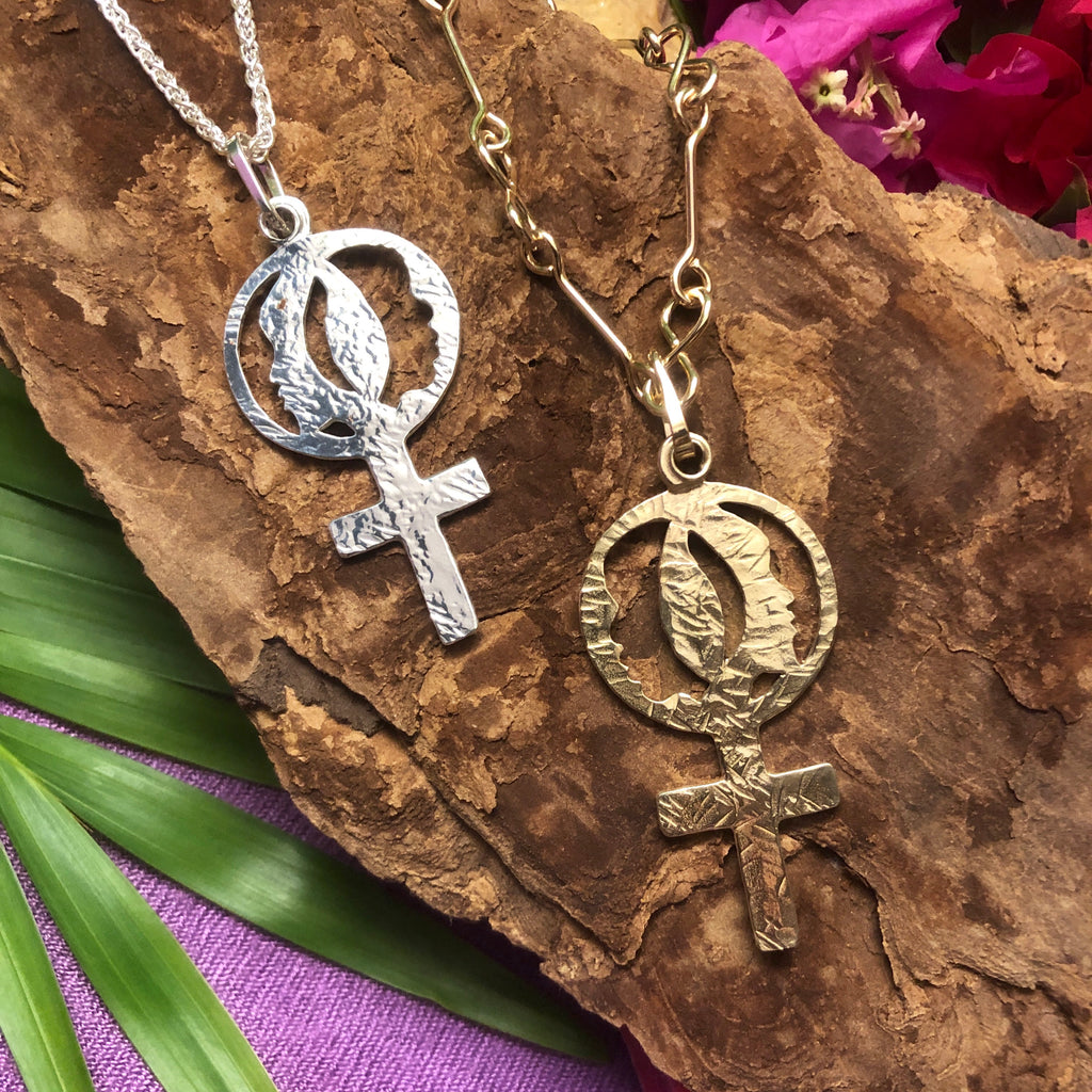 Sterling silver and 14k gold pendants with Women's Coalition venus symbol.